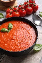 Delicious tomato cream soup served on grey table