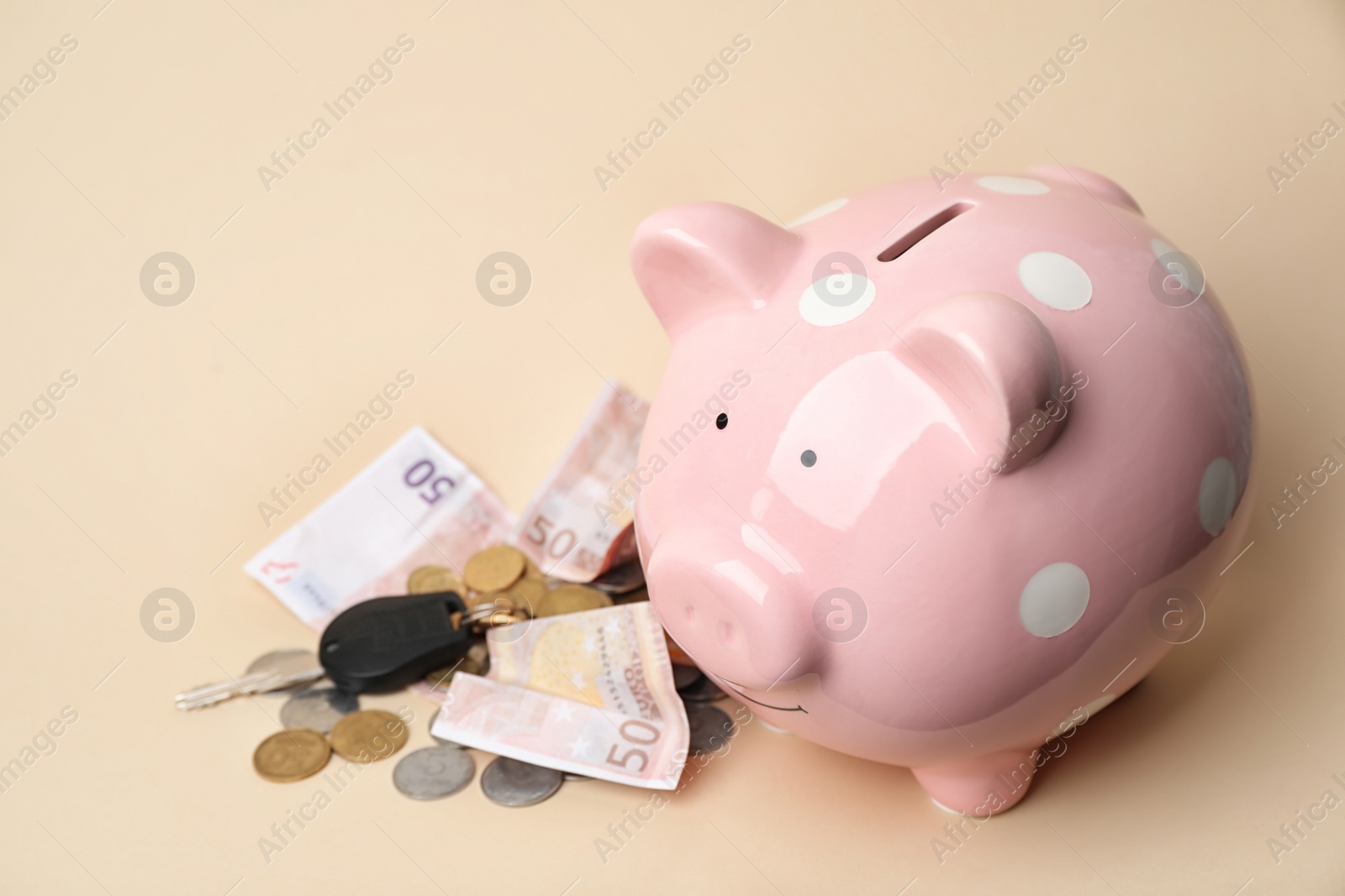 Photo of Piggy bank with money on color background. Space for text