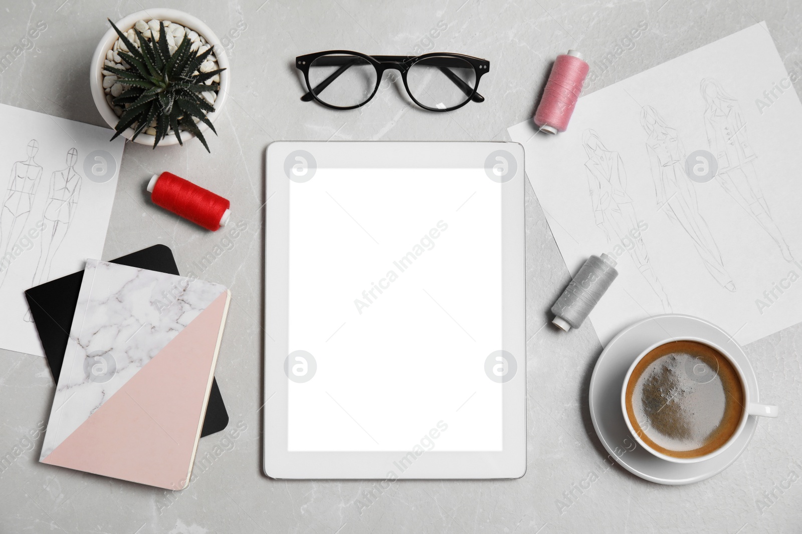 Photo of Flat lay composition with modern tablet and accessories on grey marble table. Designer's workplace