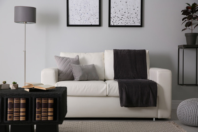 Photo of Modern comfortable sofa in stylish living room interior