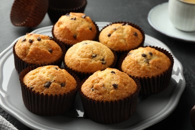 Delicious freshly baked muffins with chocolate chips on table, closeup