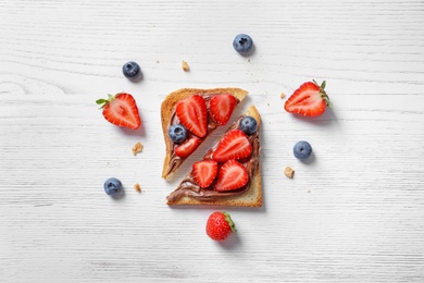 Flat lay composition with toast bread, strawberry and blueberry on light background