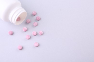 Photo of Jar with vitamin pills on white background, flat lay. Space for text