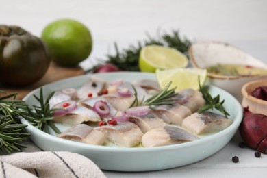 Photo of Tasty marinated fish with rosemary and spices on light table, closeup