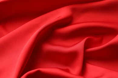 Crumpled red silk fabric as background, closeup