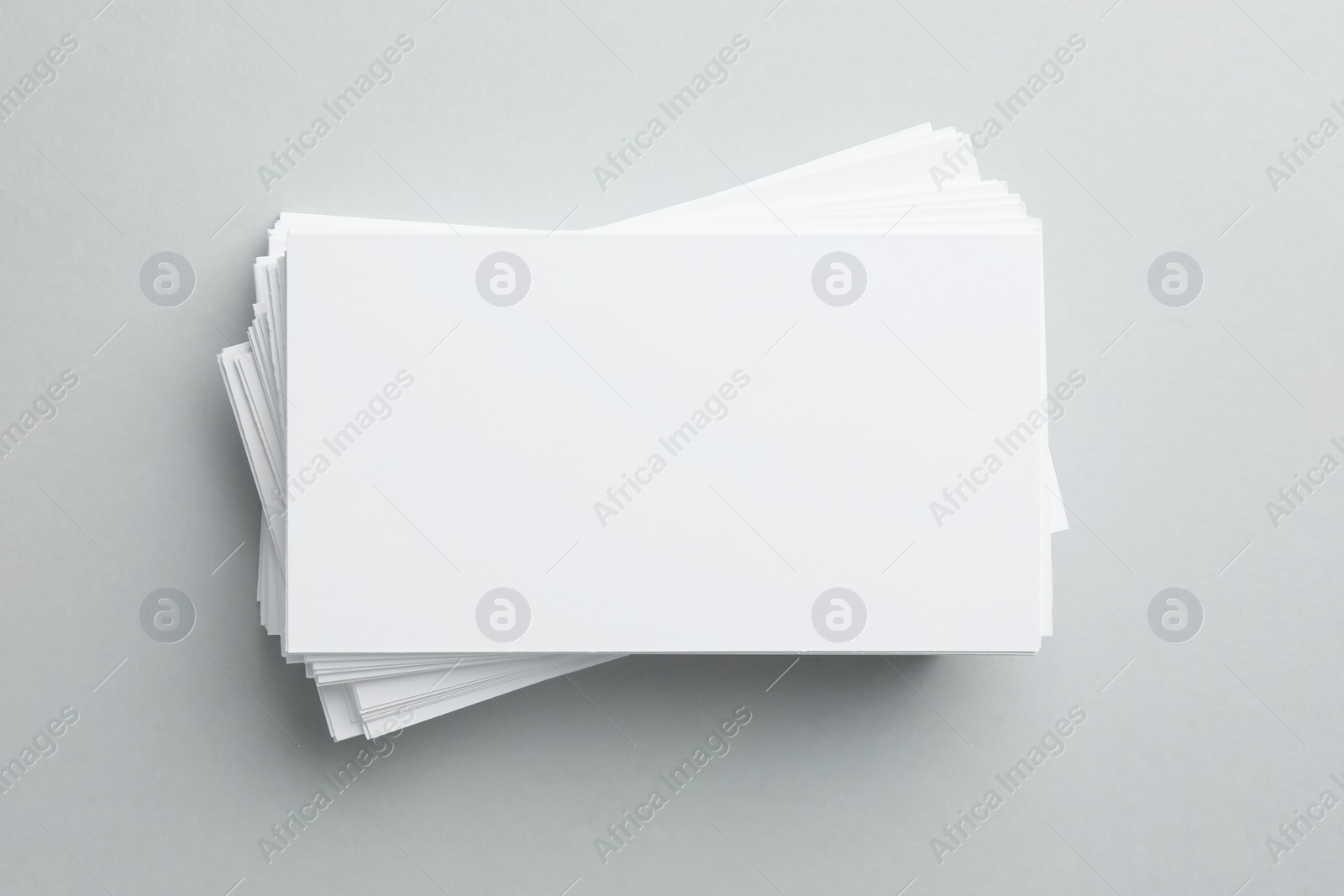 Photo of Blank business cards on light gray background, top view. Mockup for design