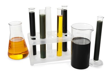 Test tubes, beaker and flask with different types of oil isolated on white