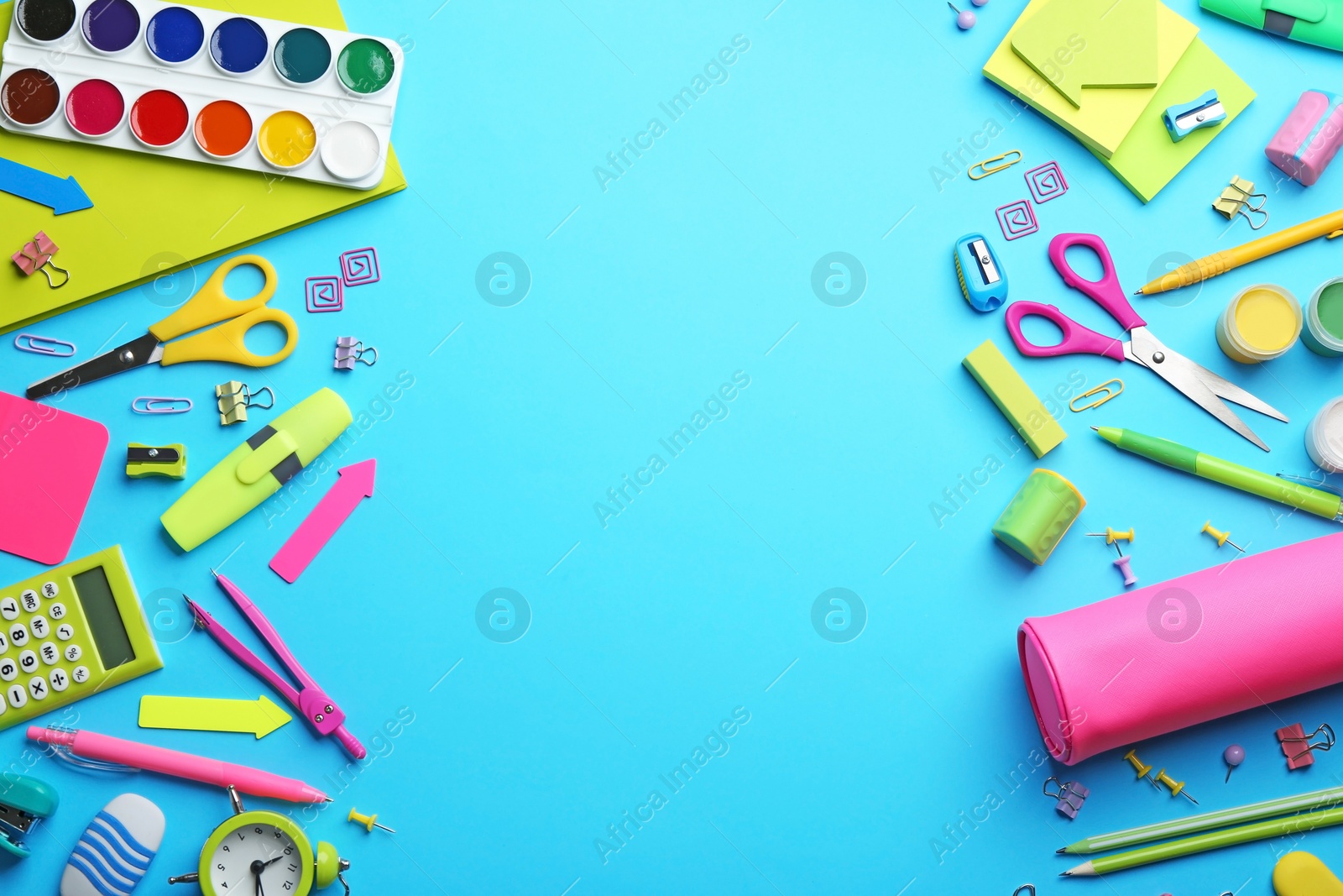 Photo of Frame made with colorful school stationery on light blue background, flat lay. Space for text