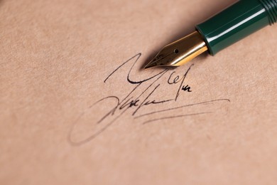 Photo of Signing on sheet of paper with fountain pen, closeup