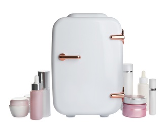 Photo of Cosmetics refrigerator and skin care products on white background