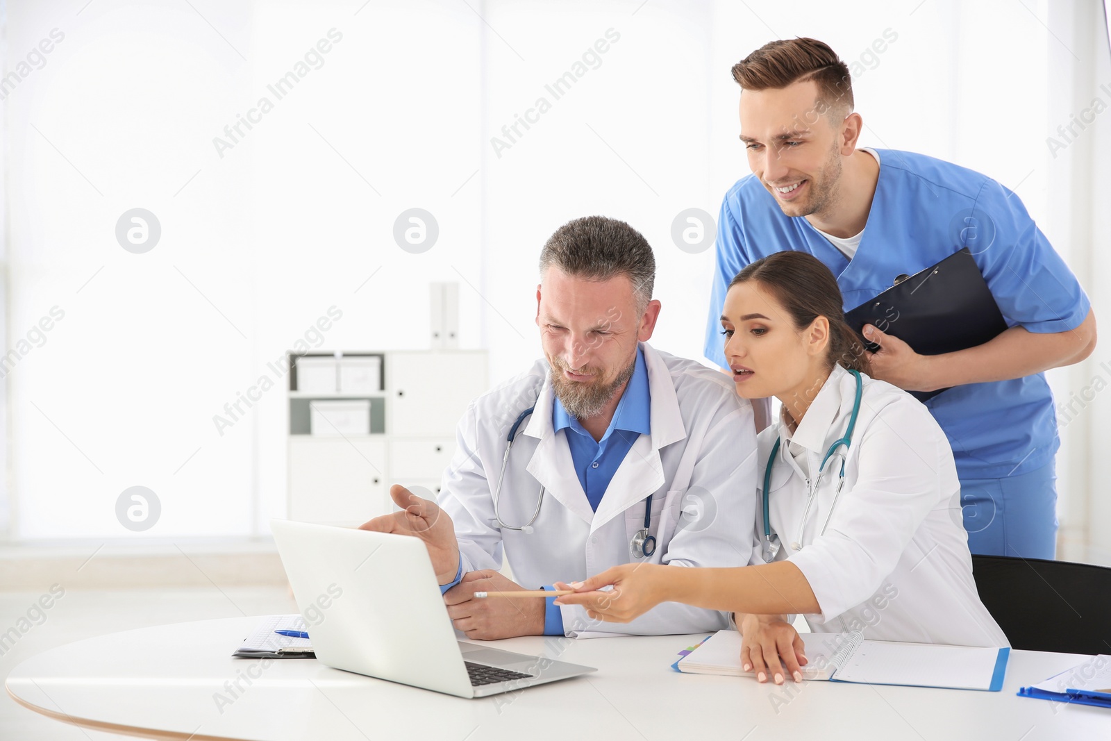 Photo of Group of doctors attending meeting in clinic. Cardiology conference