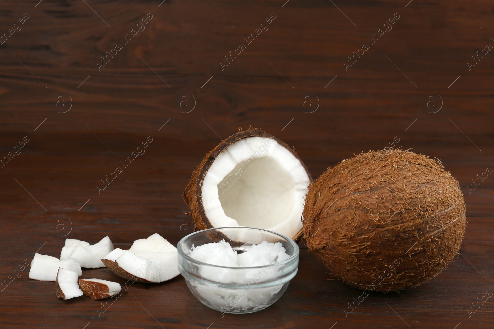 Photo of Composition with organic coconut oil on wooden table. Healthy cooking