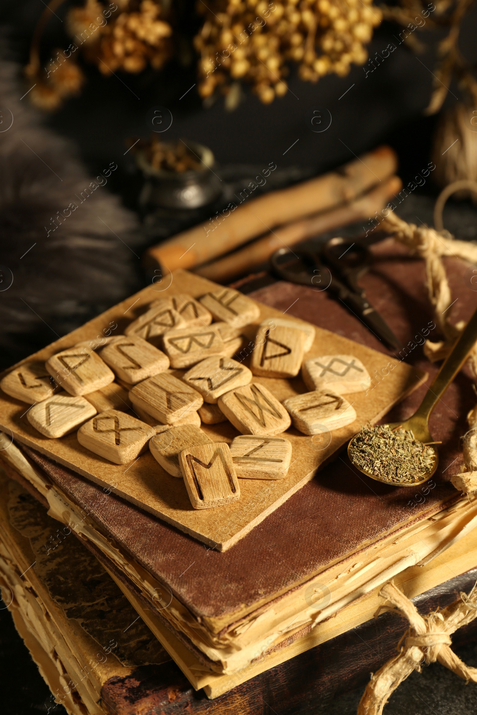 Photo of Many wooden runes and old books on altar