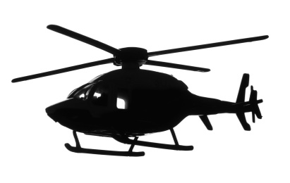 Dark silhouette of toy military helicopter on white background
