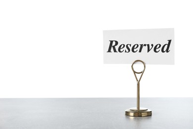 Elegant sign Reserved on light grey table against white background, space for text