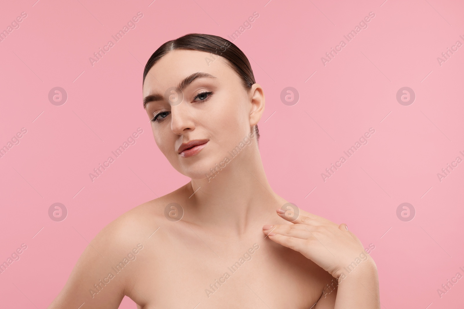 Photo of Portrait of beautiful woman on pink background