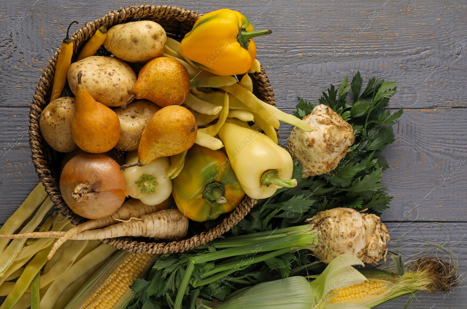 Photo of Different fresh ripe vegetables and fruits on grey wooden table, flat lay