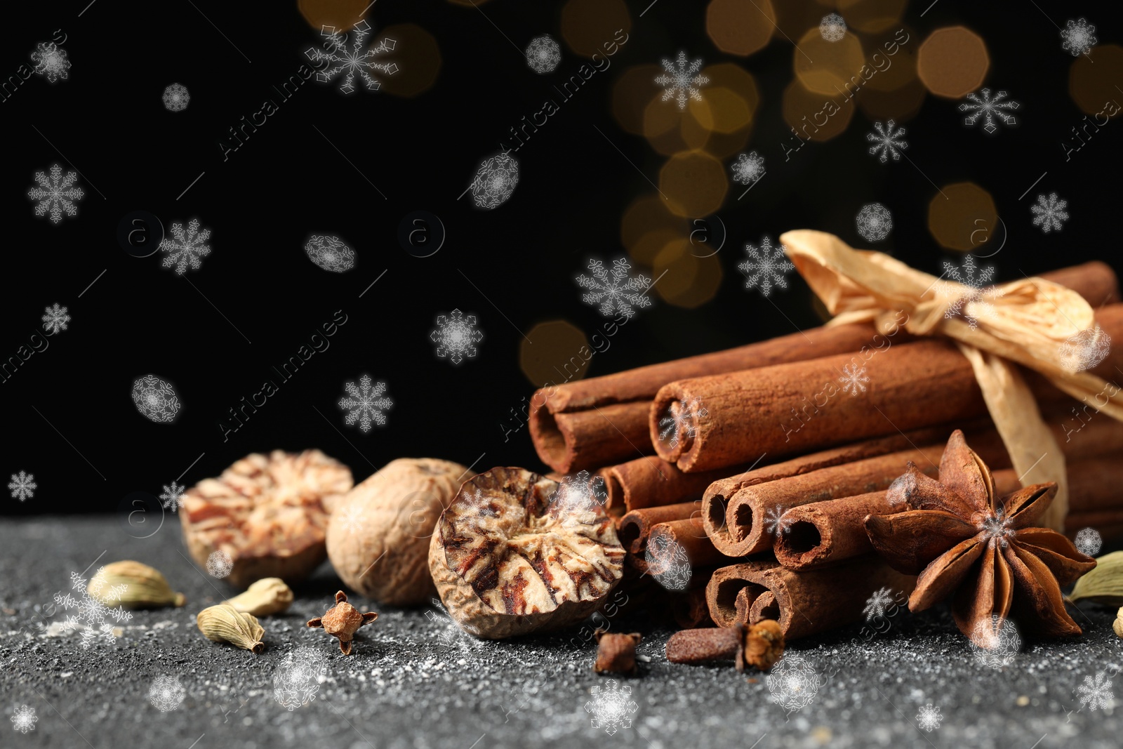 Image of Different spices on grey table, closeup. Cinnamon, anise, cloves, cardamom, nutmegs