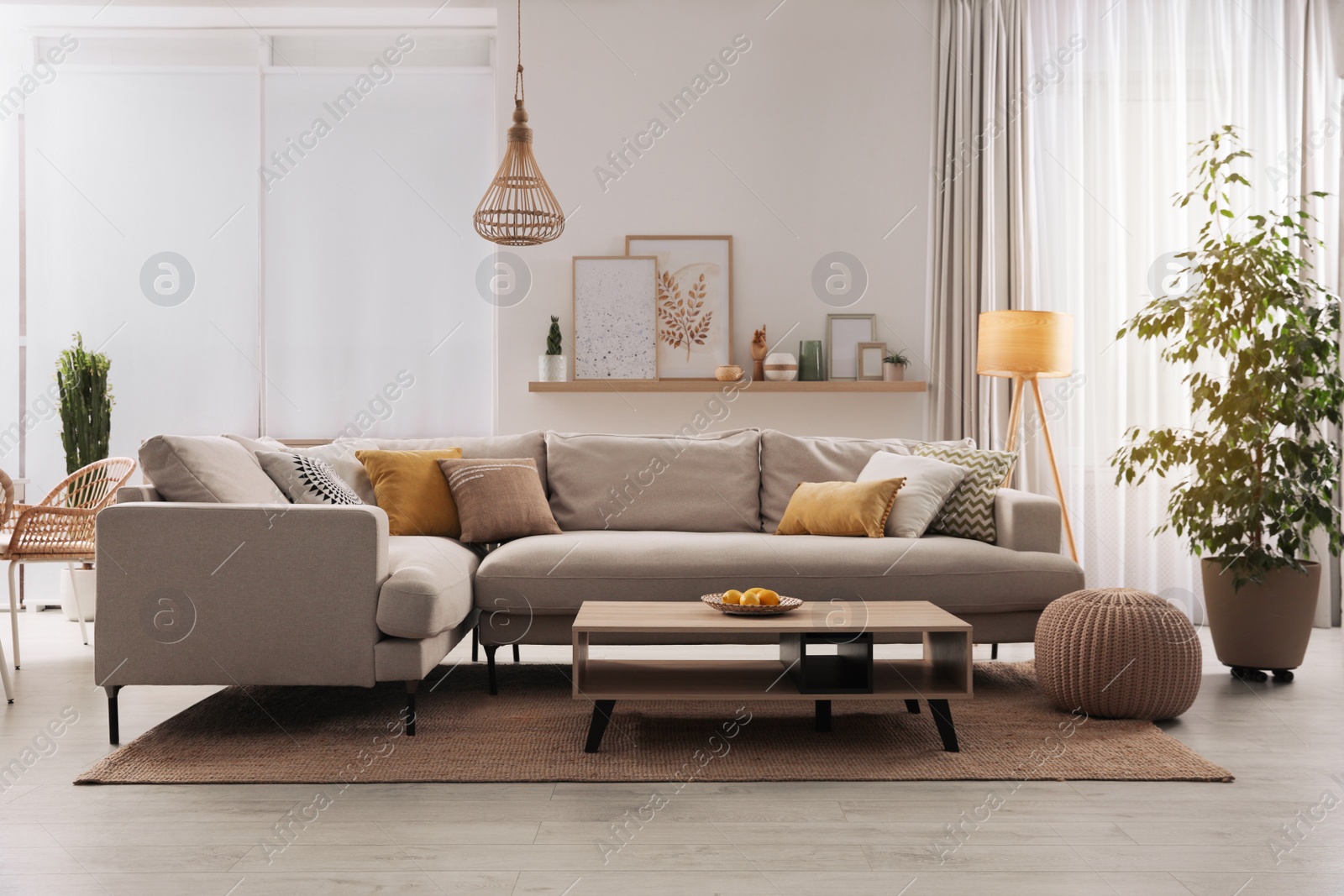 Photo of Stylish living room interior with comfortable grey sofa and coffee table