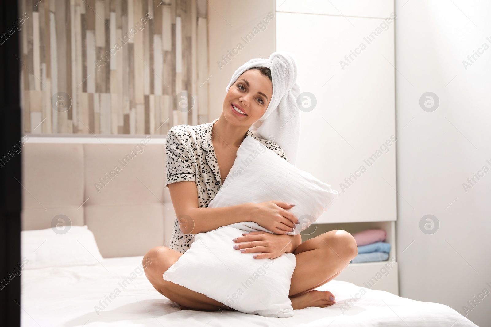 Photo of Beautiful woman with soft pillow at home. Bedtime