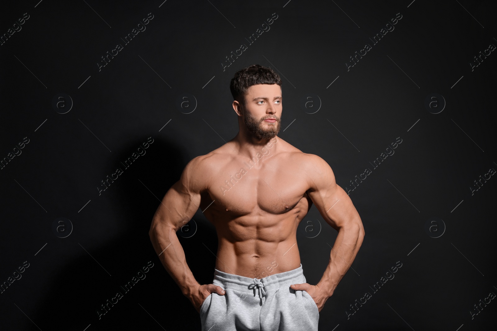 Photo of Handsome muscular man on black background. Sexy body