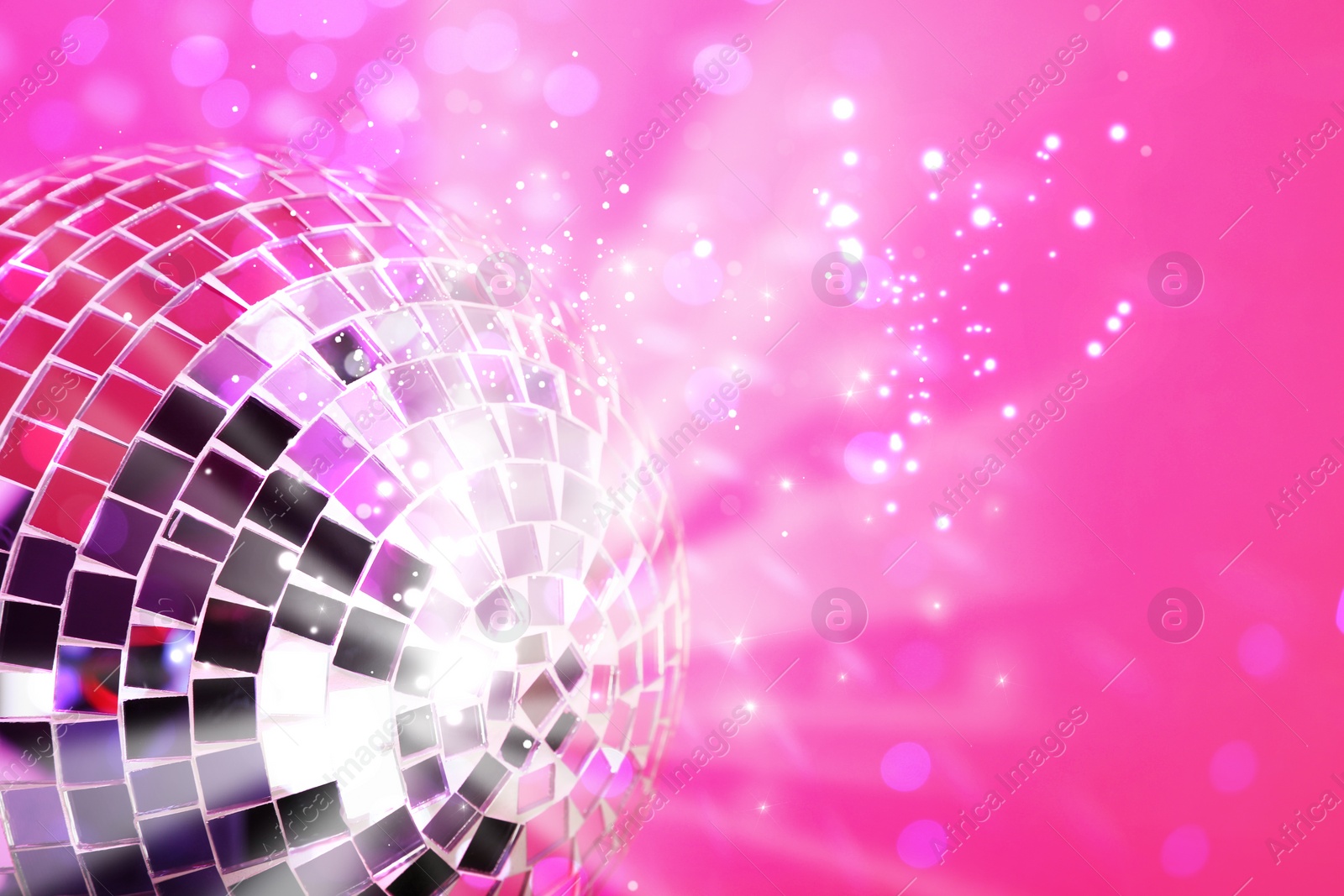 Image of Shiny disco ball on pink background with blurred lights, space for text. Bokeh effect