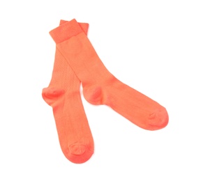 Photo of Orange socks on white background, top view