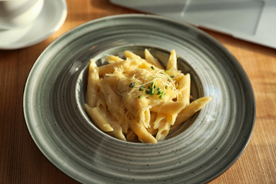 Photo of Tasty pasta with cheese on wooden table