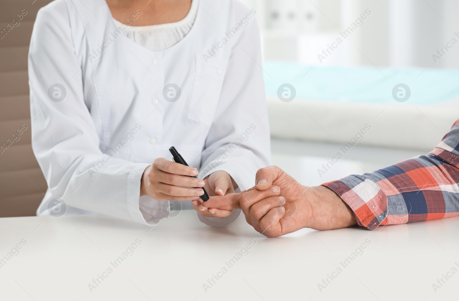 Photo of Doctor taking patient's blood sample with lancet pen in hospital, closeup. Diabetes control