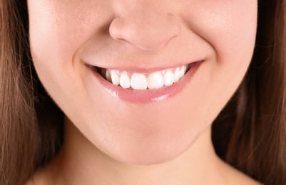 Photo of Young woman with beautiful smile, closeup view