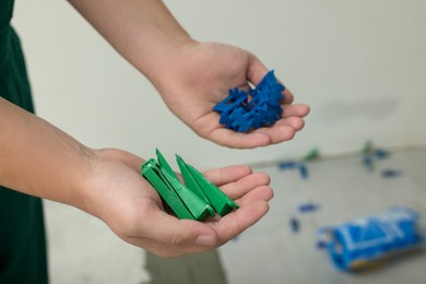 Man holding colorful tile wedges indoors, closeup