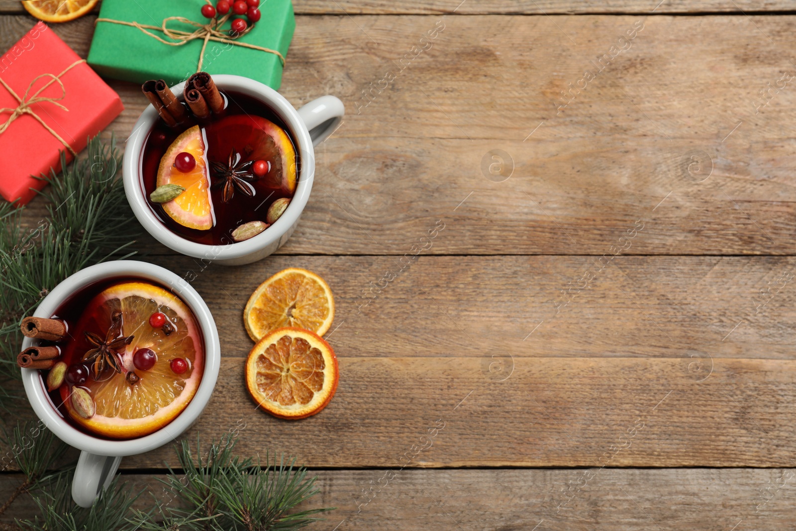 Photo of Flat lay composition with tasty mulled wine on wooden table. Space for text