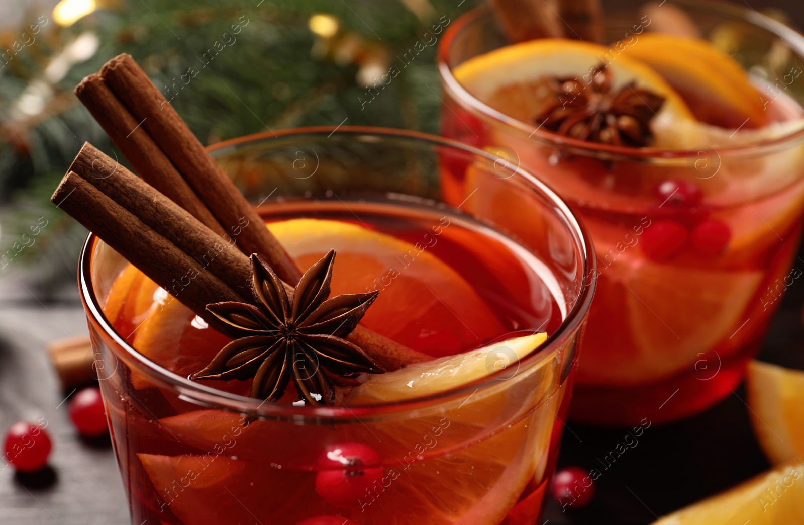 Photo of Glass with delicious punch drink on table. closeup