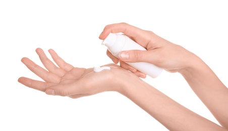 Photo of Young woman applying hand cream against on white background