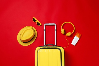 Photo of Flat lay composition with stylish suitcase and accessories on color background