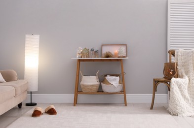 Modern room interior with table near light wall