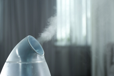 Modern air humidifier indoors, closeup. Space for text