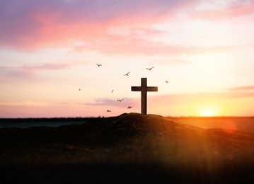 Image of Christian cross on hill outdoors at sunset. Crucifixion Of Jesus