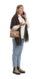 Photo of Senior woman with bag talking on smartphone against white background