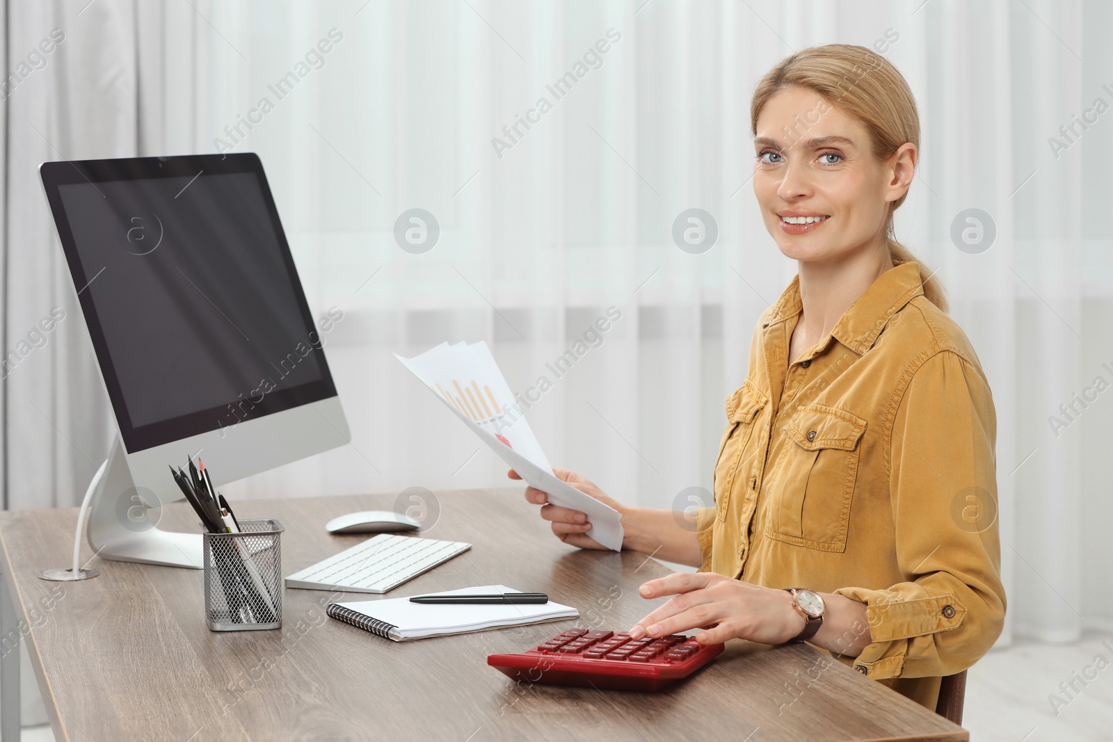 Photo of Professional accountant working at wooden desk in office