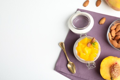 Photo of Tasty peach dessert with yogurt served on white table, flat lay. Space for text