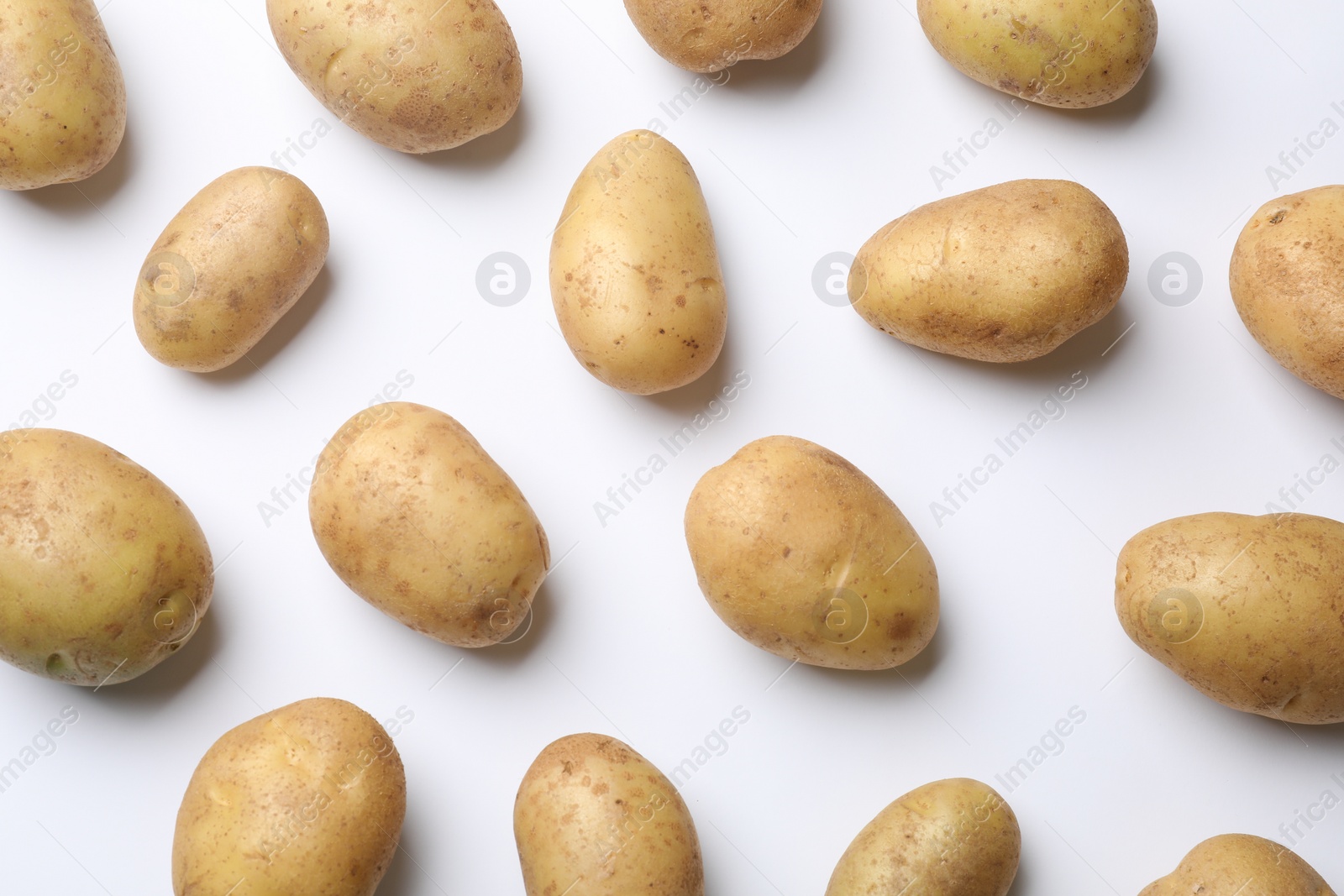 Photo of Fresh raw potatoes on white background, flat lay