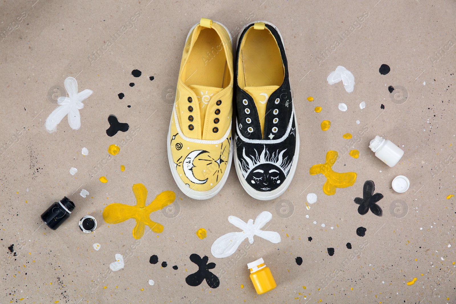 Photo of Amazing customized shoes and painting supplies on color background, flat lay