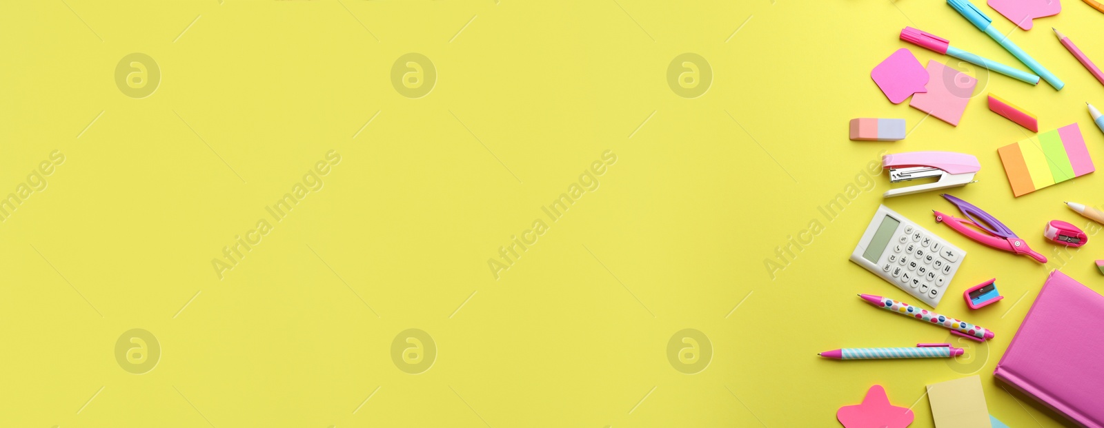 Photo of School stationery on yellow background, flat lay with space for text. Back to school