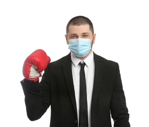 Photo of Businessman with protective mask and boxing gloves on white background. Strong immunity concept