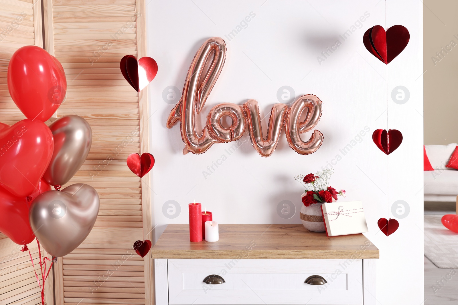 Photo of Cozy room decorated for Valentine's Day with heart shaped balloons. Interior design