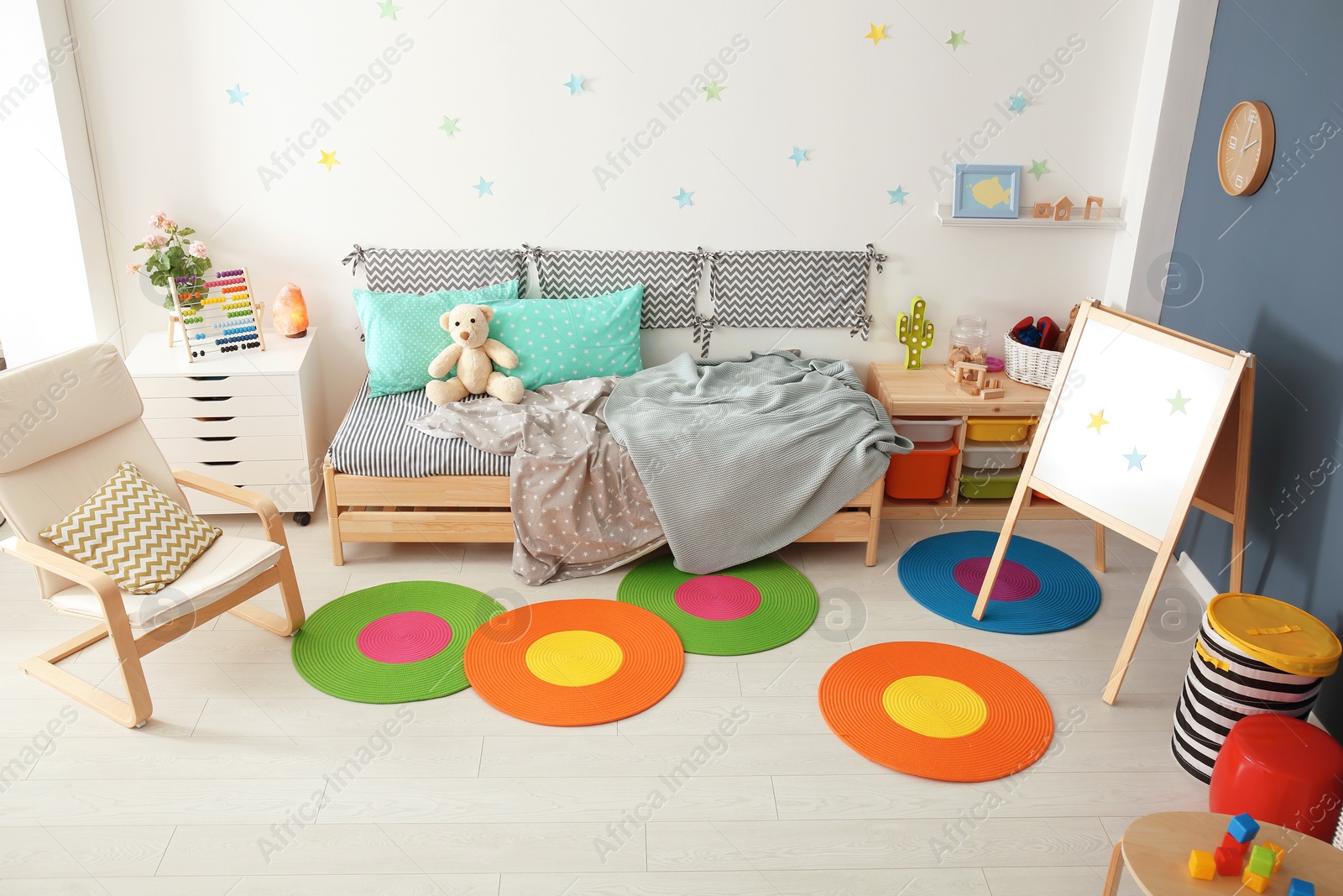 Photo of Modern child room interior with comfortable bed and armchair