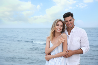 Photo of Happy couple on beach, space for text. Romantic walk