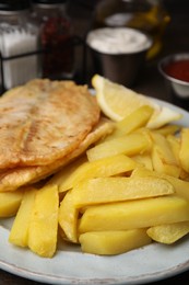 Delicious fish and chips on table, closeup