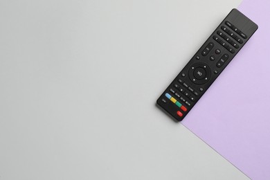 Photo of Modern tv remote control on color background, top view. Space for text